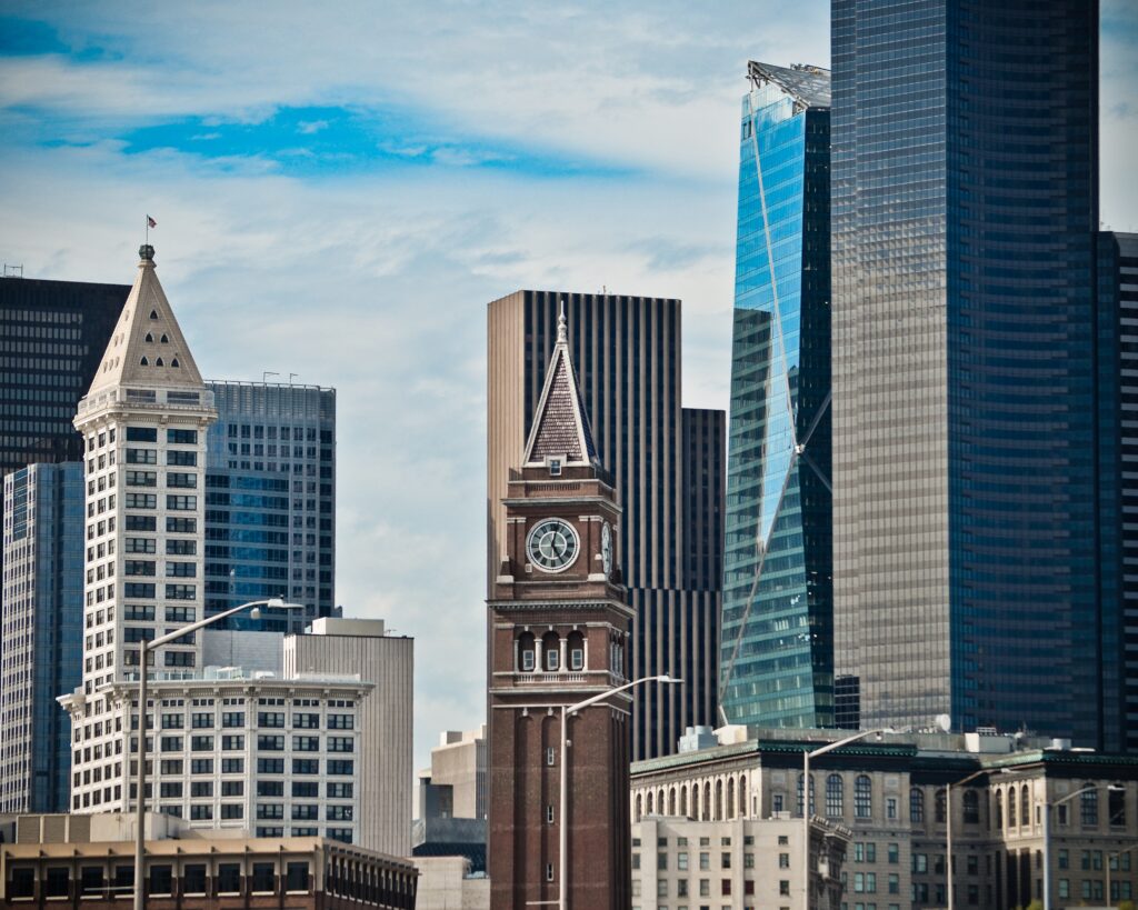 A photo of Seattle buildings in the International District and Pioneer Square, including Smith Tower and the clock tower at King Street Station.